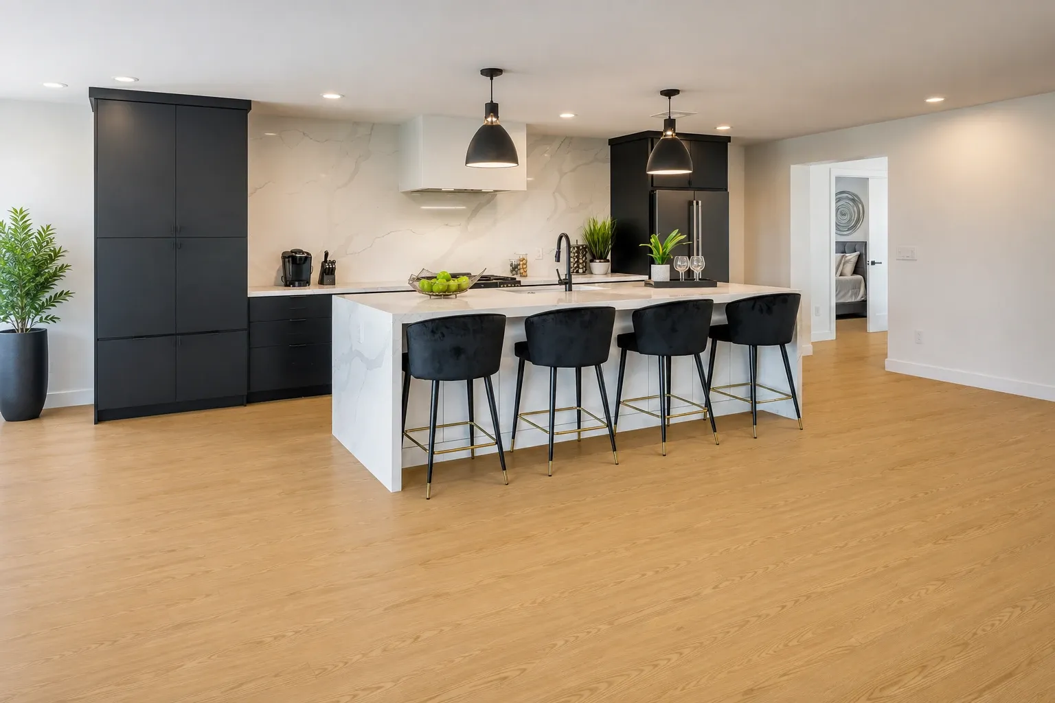 matte hardwood flooring in a modern kitchen with black cabinetry